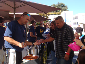 image of a man serving food at the Firefighter Chili Cook-Off