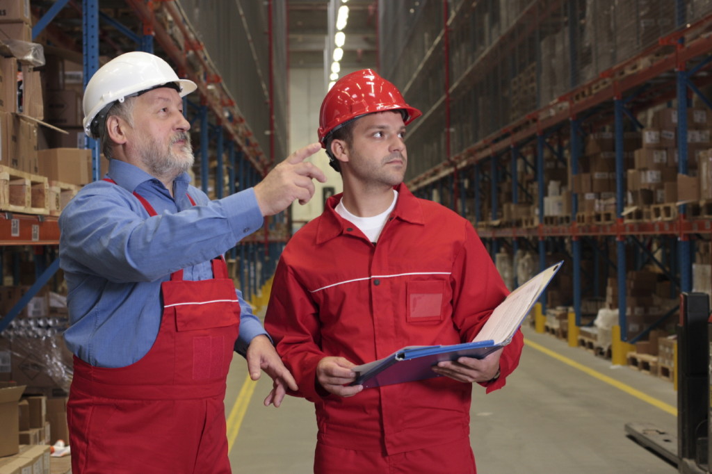 two workers in uniforms in warehouse